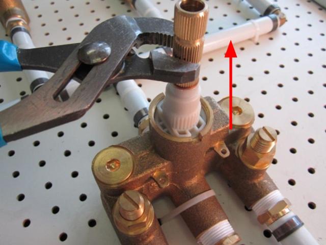 Using a pair of adjustable pliers, hold the cartridge and pull up until it is complete removed from the faucet body.