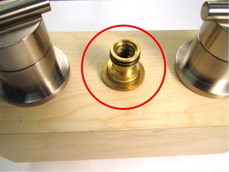 Once the spout has been removed, the spout adapter should be visible. To remove the spout adapter, use a pair of adjustable plyers. Using the plyers, turn counter clockwise until the spout adapter is removed.