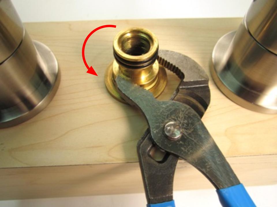 Once the spout has been removed, the spout adapter should be visible. To remove the spout adapter, use a pair of adjustable plyers. Using the plyers, turn counter clockwise until the spout adapter is removed.
